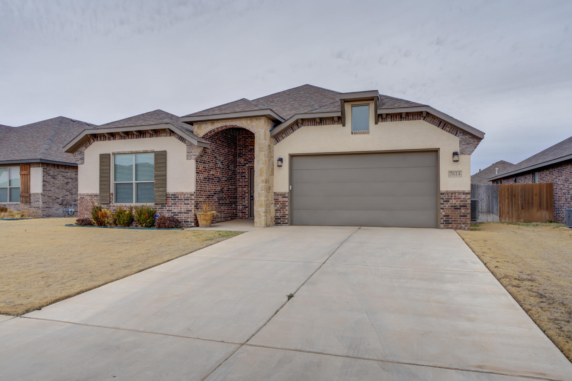 7614 62nd Street Lubbock, TX 79407 - Photo 15 of 54 a front view of a house with a yard and garage
