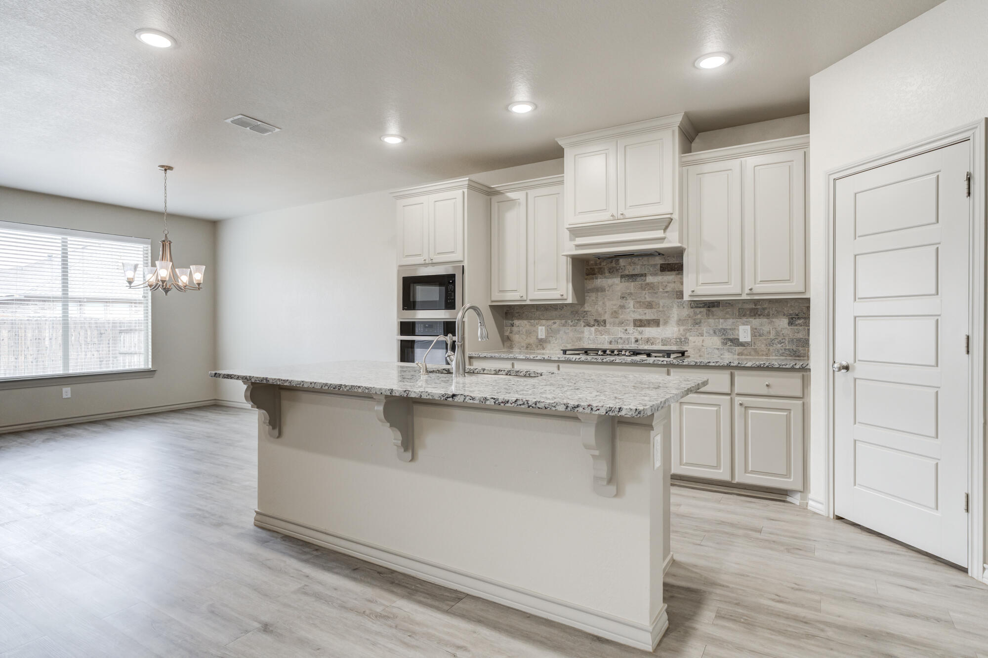 7614 62nd Street Lubbock, TX 79407 - Photo 27 of 54 a kitchen with stainless steel appliances granite countertop a sink a stove and a refrigerator