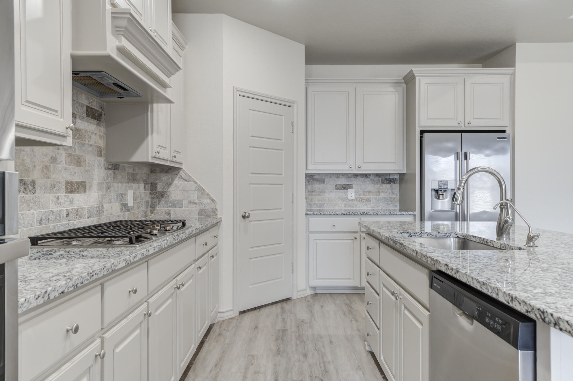 7614 62nd Street Lubbock, TX 79407 - Photo 31 of 54 a kitchen with granite countertop a sink stove and cabinets