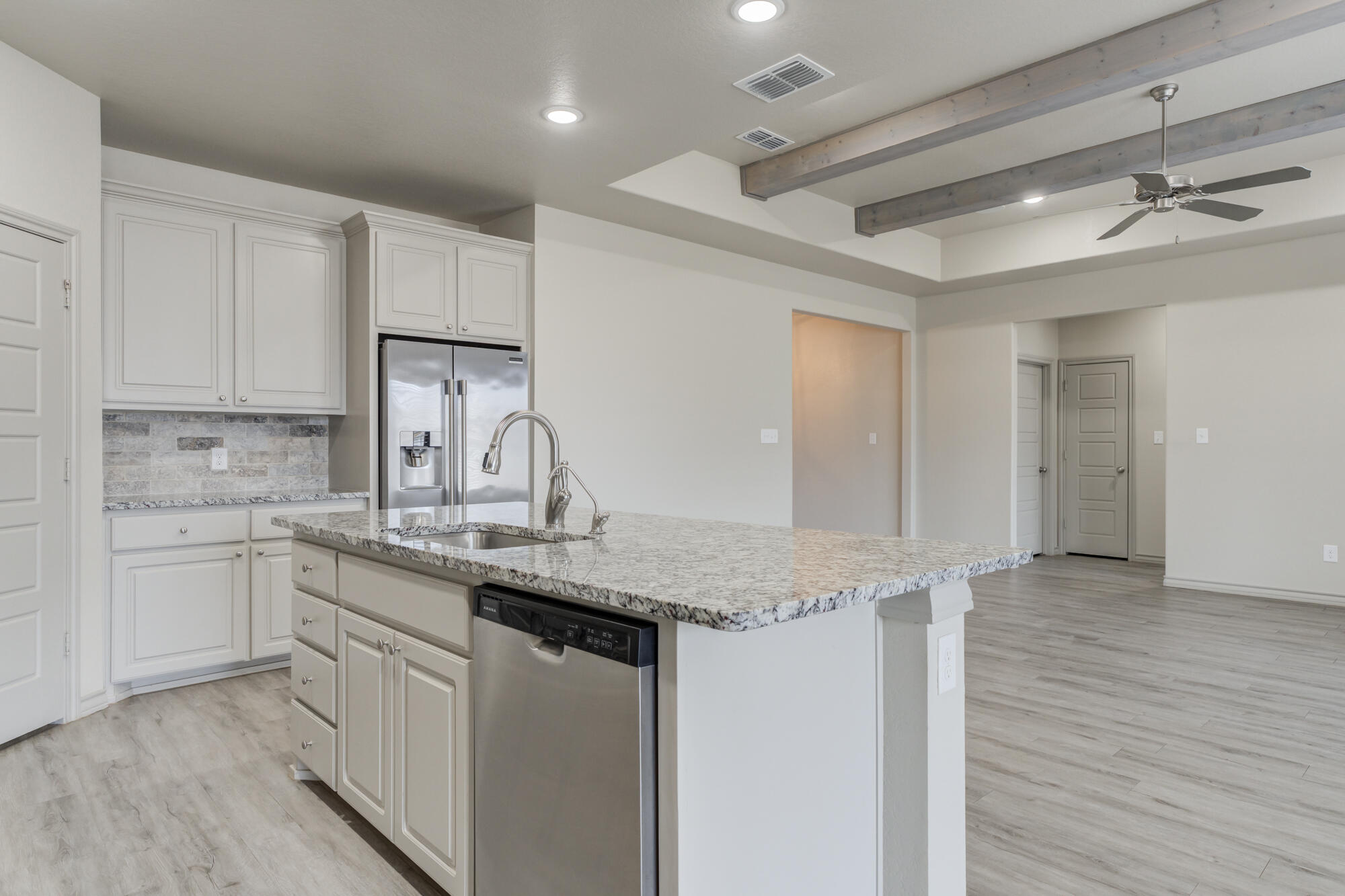 7614 62nd Street Lubbock, TX 79407 - Photo 32 of 54 a kitchen with stainless steel appliances granite countertop a sink cabinets and wooden floor