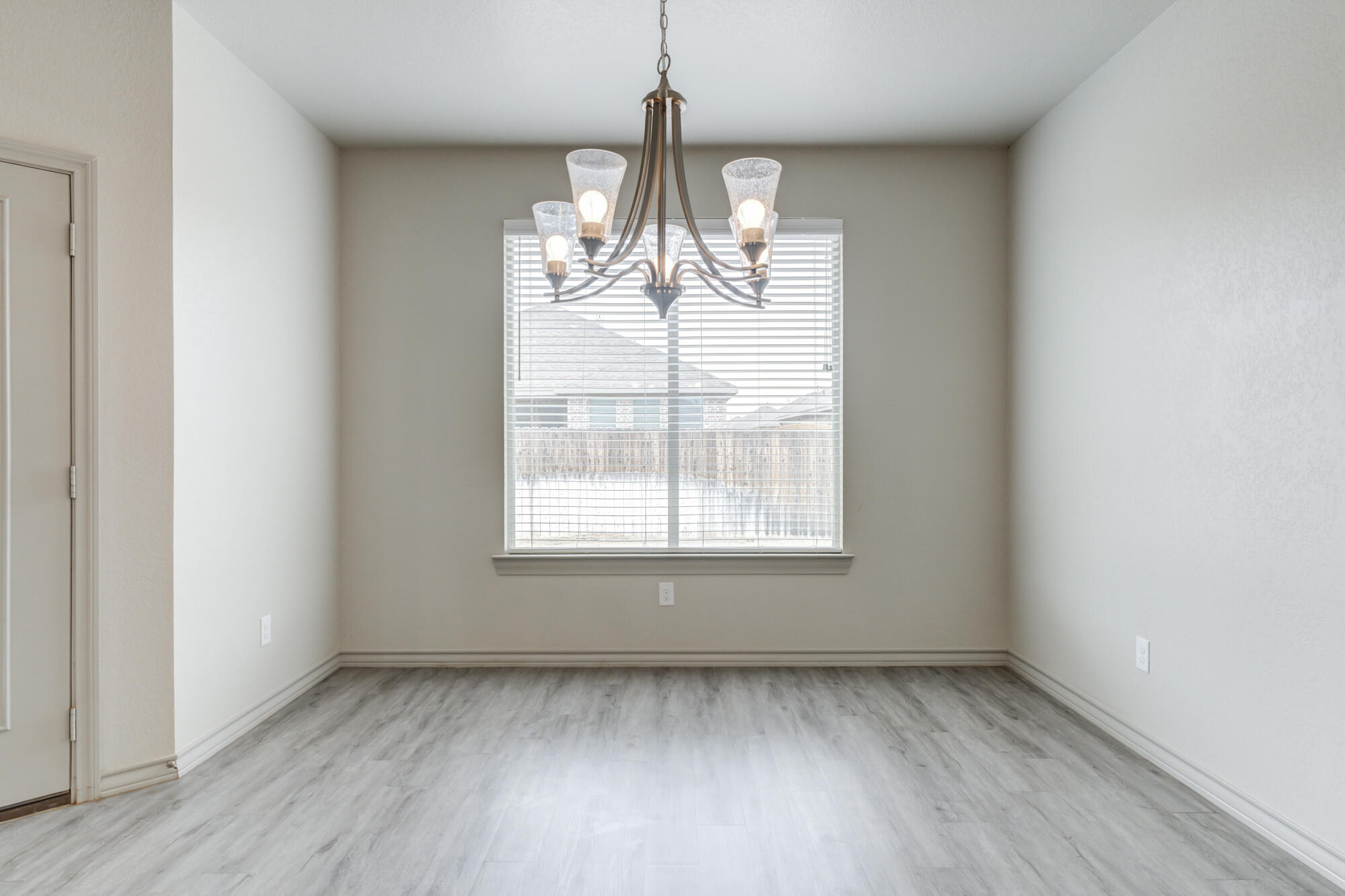 7614 62nd Street Lubbock, TX 79407 - Photo 33 of 54 an empty room with wooden floor and windows