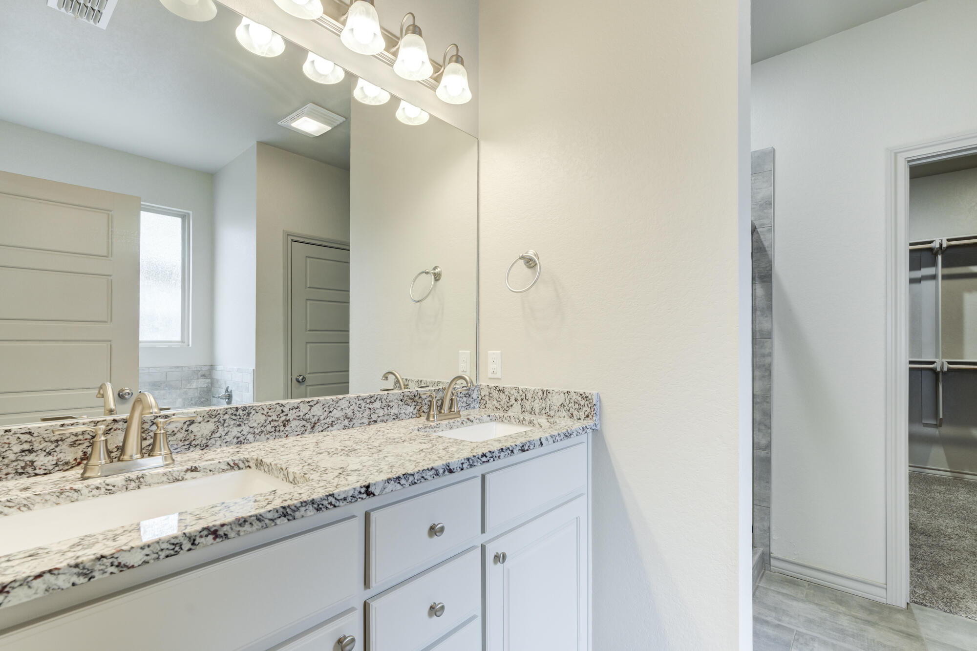 7614 62nd Street Lubbock, TX 79407 - Photo 36 of 54 a bathroom with a granite countertop double vanity sink and a mirror
