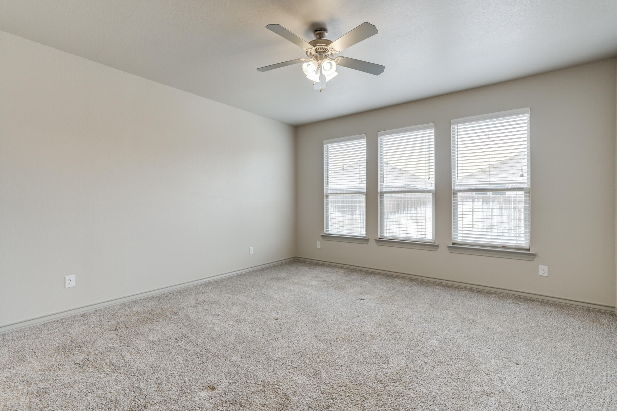 7614 62nd Street Lubbock, TX 79407 - Photo 5 of 54 wooden floor in an empty room with a window