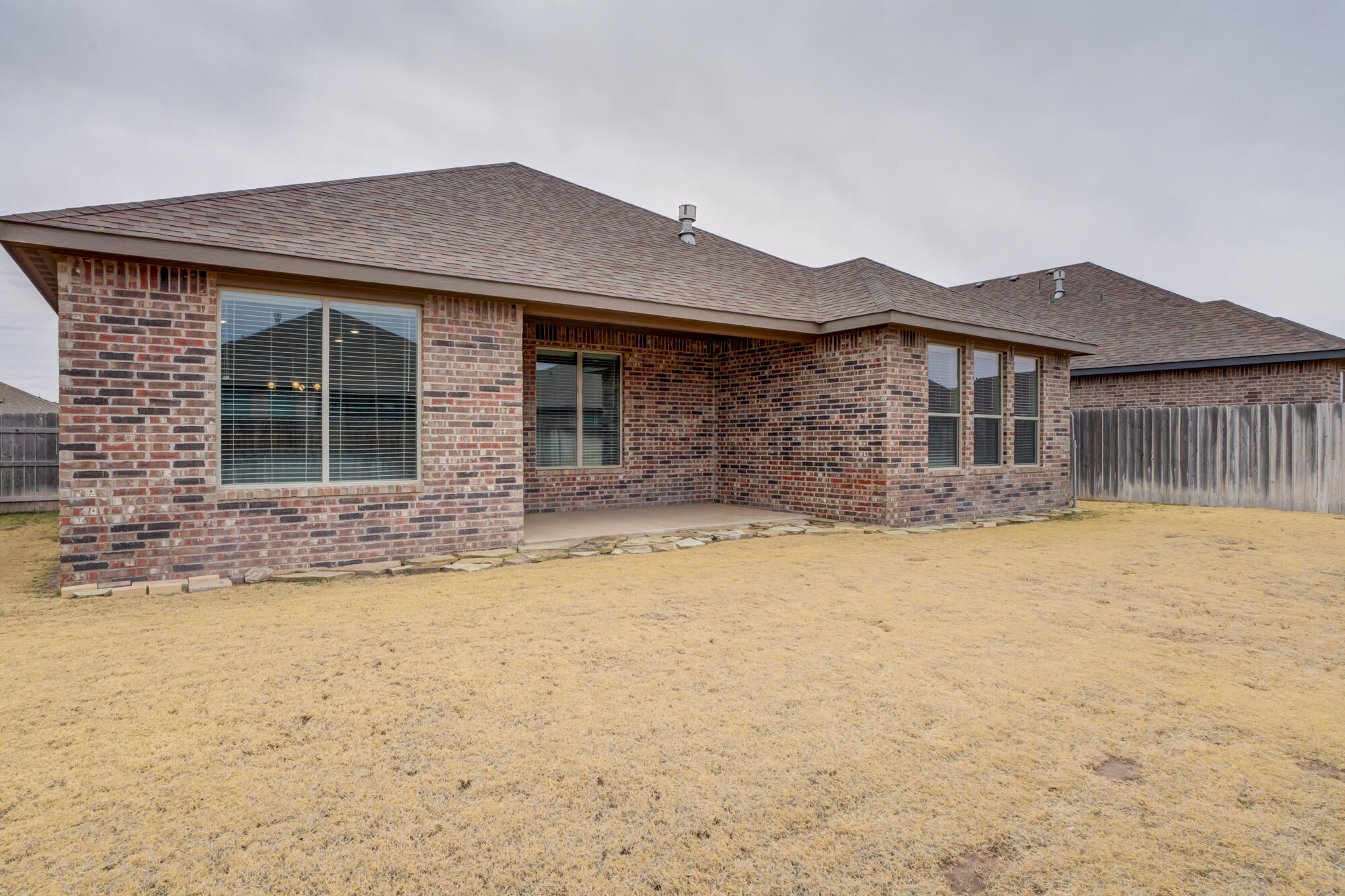 7614 62nd Street Lubbock, TX 79407 - Photo 52 of 54 a front view of a house with a yard