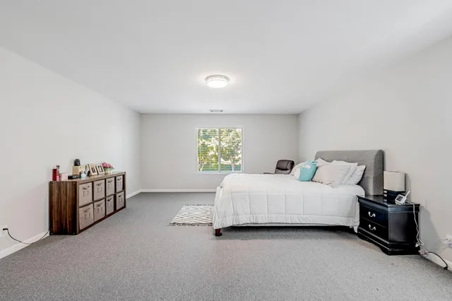 a bed room with a bed and a window