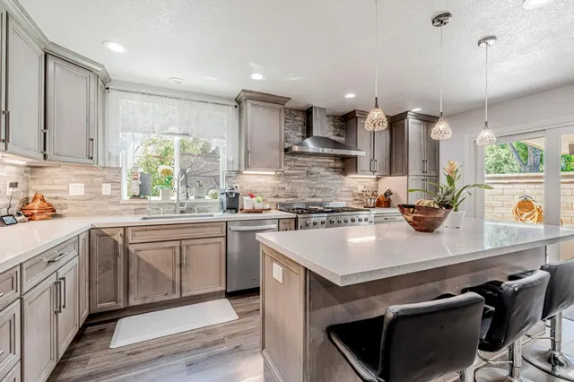 a kitchen with a sink stove and cabinets