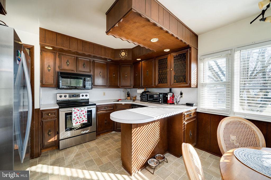 504 Harding Avenue Reading, PA 19607 - Photo 16 of 45 a kitchen with stainless steel appliances granite countertop a sink a stove a refrigerator cabinets and a dining table