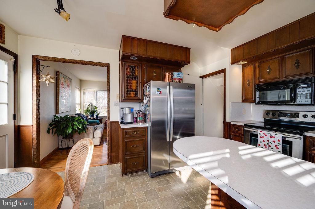 504 Harding Avenue Reading, PA 19607 - Photo 21 of 45 a kitchen with stainless steel appliances a refrigerator and a dining table