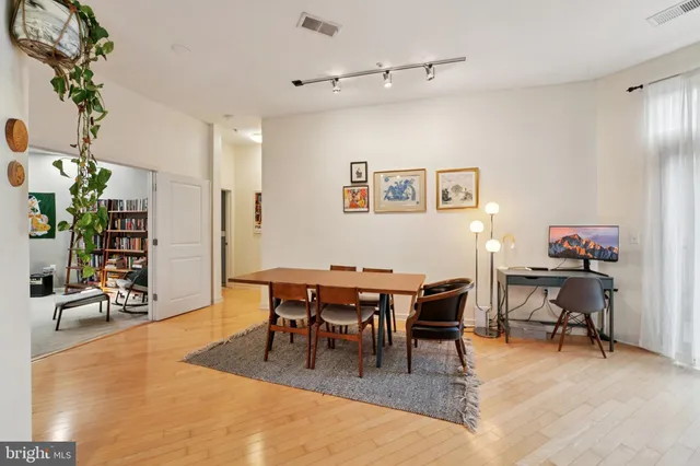 a dining room with wooden floor and breakfast area