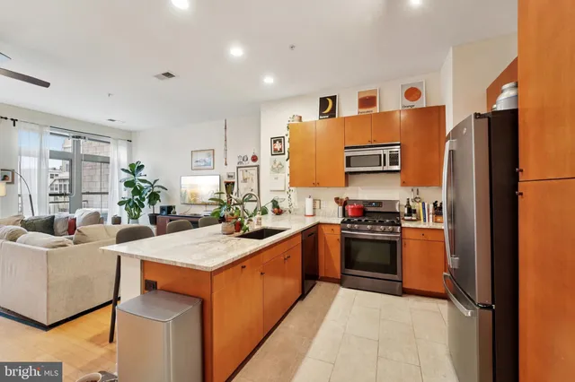 a kitchen with stainless steel appliances granite countertop a refrigerator and a sink