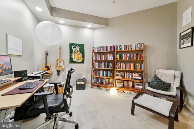 a view of a workspace with furniture and white cabinet