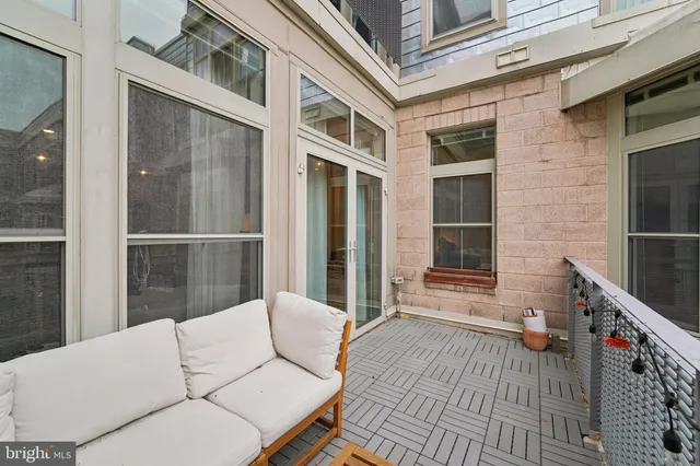 a balcony with furniture and a potted plant