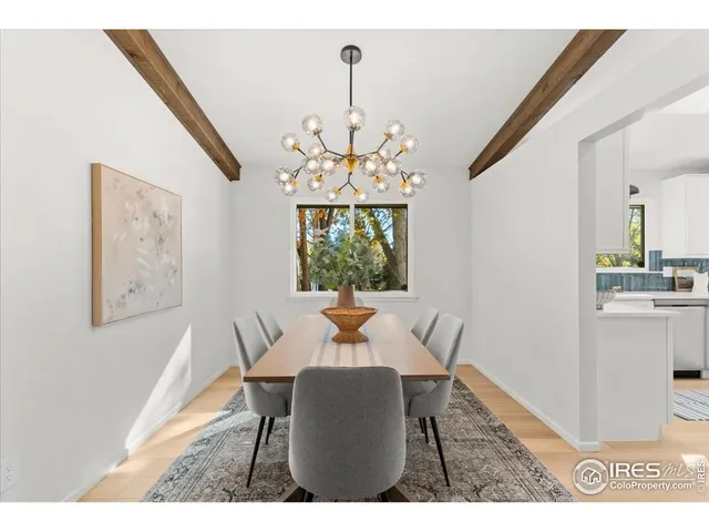 a view of a dining room with furniture and a chandelier