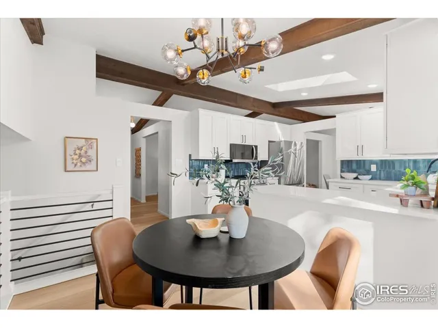 a dining room with furniture and wooden floor