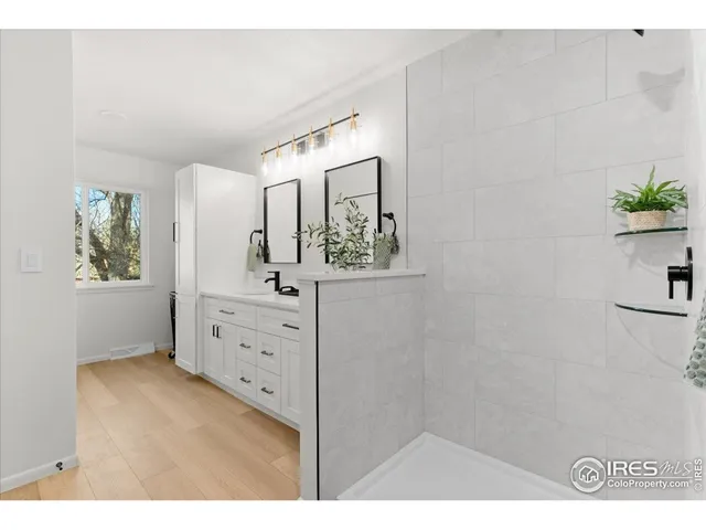 a bathroom with a sink a mirror and a vanity