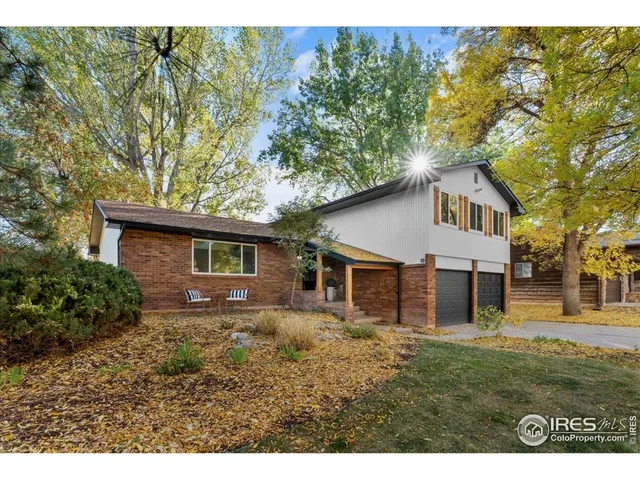 a house that has a tree in front of the house