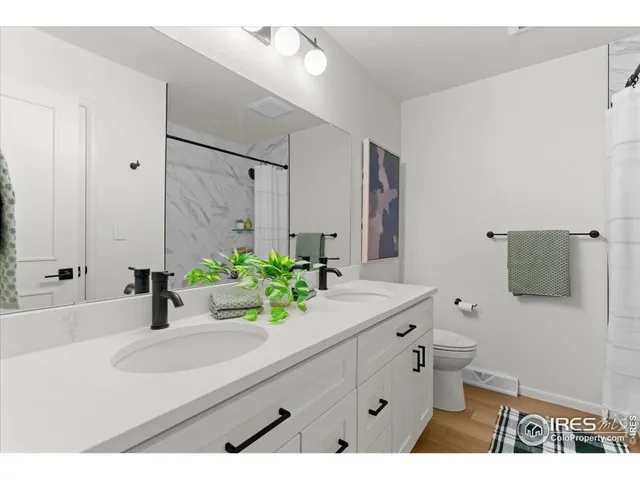 a bathroom with a sink double vanity and a mirror