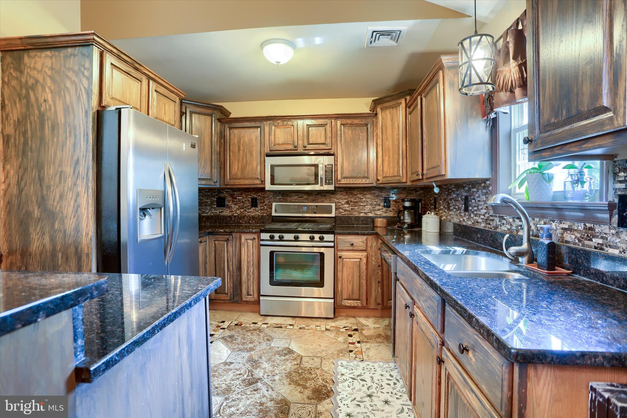 12 Edgewater Drive Middletown, PA 17057 - Photo 12 of 39 a kitchen with stainless steel appliances granite countertop a sink stove and refrigerator