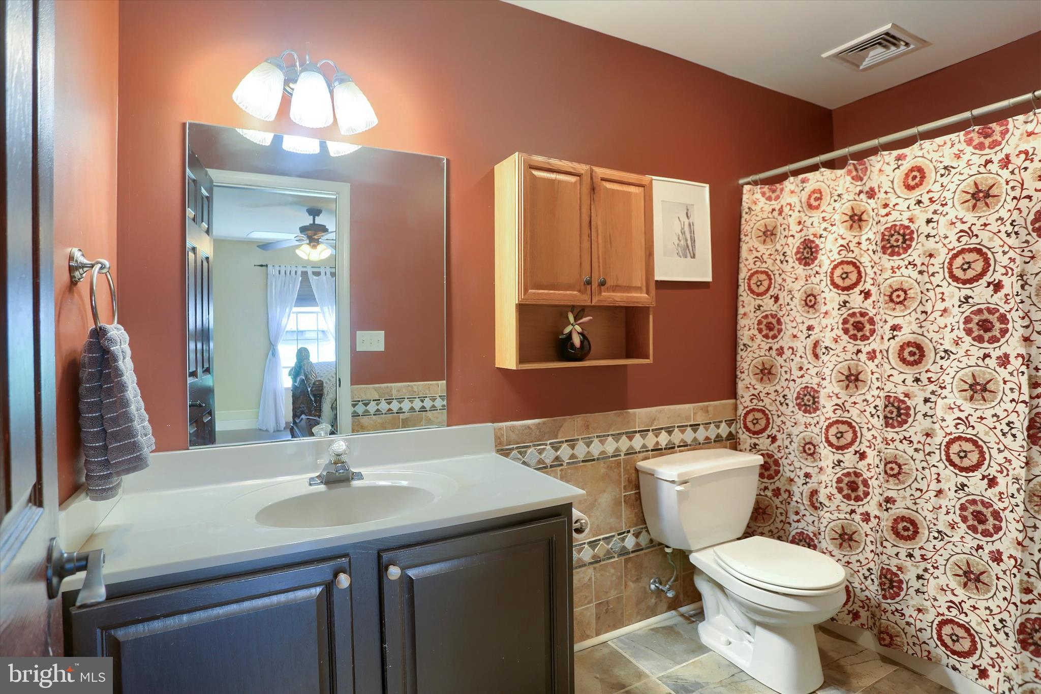 12 Edgewater Drive Middletown, PA 17057 - Photo 23 of 39 a bathroom with a sink a toilet a mirror and shower curtain