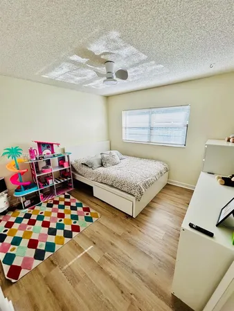 a bedroom with furniture and a baby crib