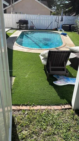 a view of a backyard with plants and outdoor seating