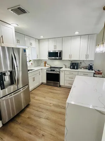 a kitchen with wooden cabinets and stainless steel appliances