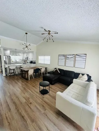 a living room with lots of furniture and chandelier