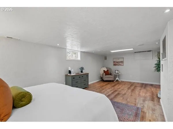 a bedroom with a bed and a painting on the wall