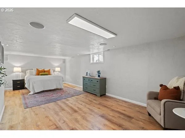 a bedroom with furniture and a wooden floor