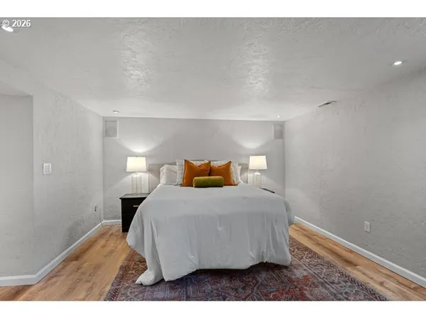 a bedroom with a bed and a night stand