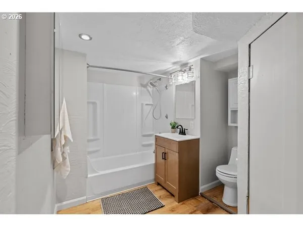 a bathroom with a shower a toilet and a sink