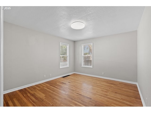 561 East Ridgeway Avenue Hermiston, OR 97838 - Photo 27 of 46 a view of an empty room with wooden floor and a window