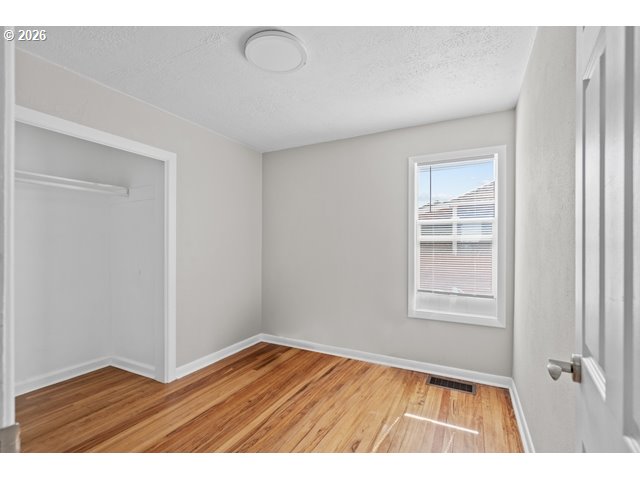 561 East Ridgeway Avenue Hermiston, OR 97838 - Photo 28 of 46 a view of an empty room with wooden floor and a window