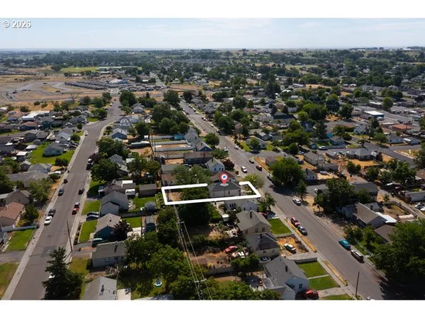 an aerial view of residential houses with outdoor space