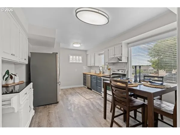 a kitchen with a table chairs and a refrigerator