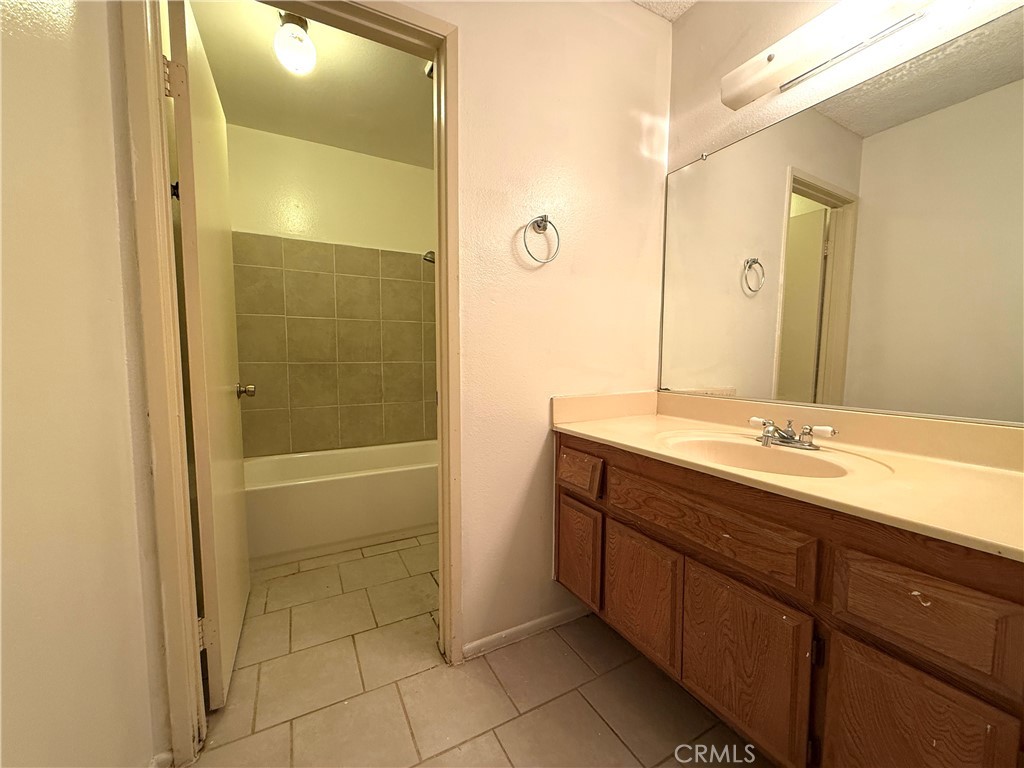 860 Cinnamon Lane, Unit 55 Duarte, CA 91010 - Photo 10 of 13 a bathroom with a granite countertop sink shower and a mirror
