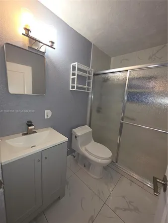 a white toilet sitting next to a bathroom sink