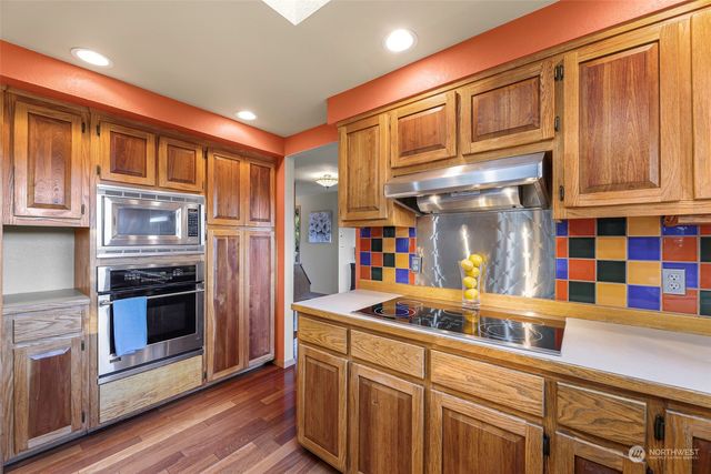 a kitchen with stainless steel appliances granite countertop a refrigerator and a sink