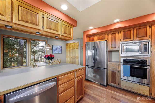 a dining room with furniture a chandelier and wooden floor