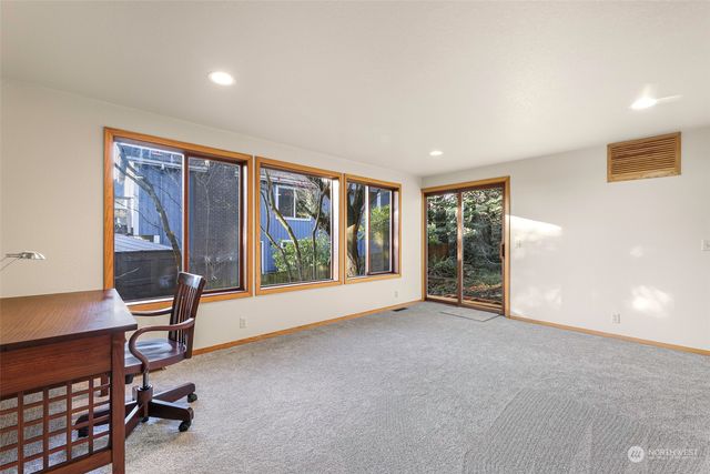 a view of an empty room with closet and a window
