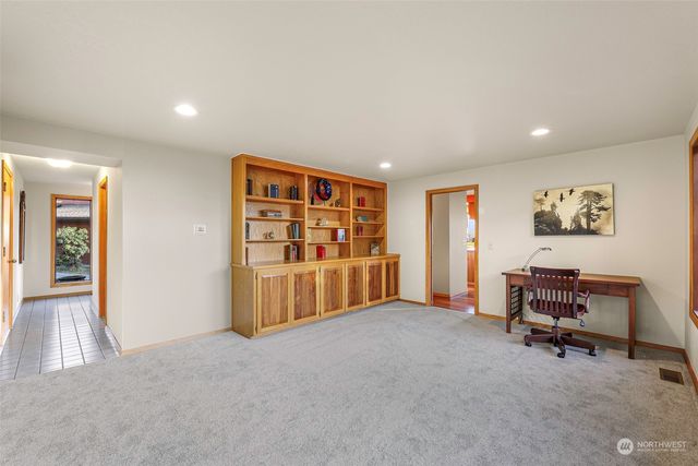 a view of a hallway view with dining room and stairs
