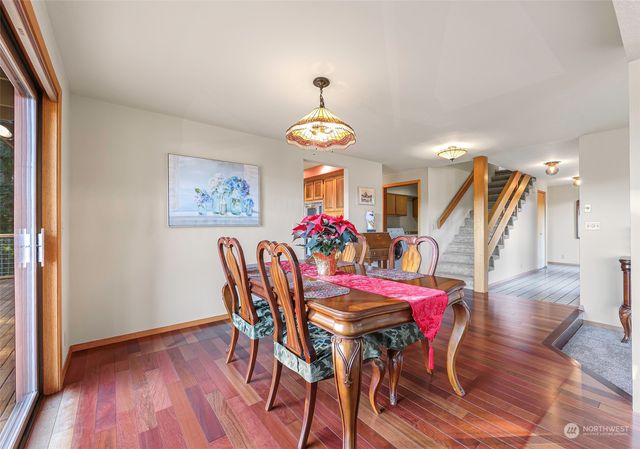 a view of a dining room with furniture wooden floor and chandelier