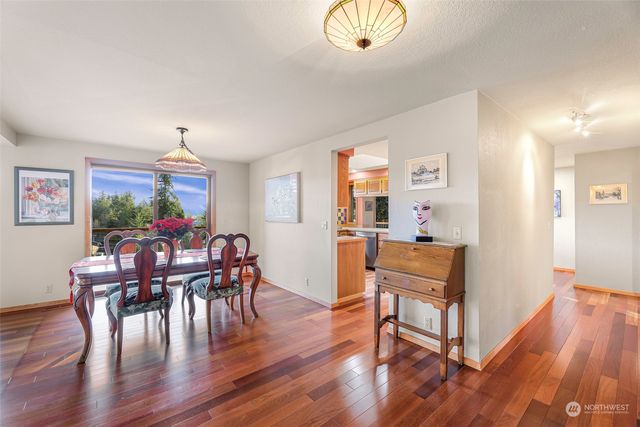 a view of a kitchen with kitchen island granite countertop a large window a sink and counter space