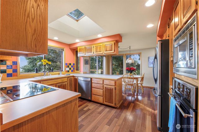 a kitchen with stainless steel appliances granite countertop a sink and cabinets