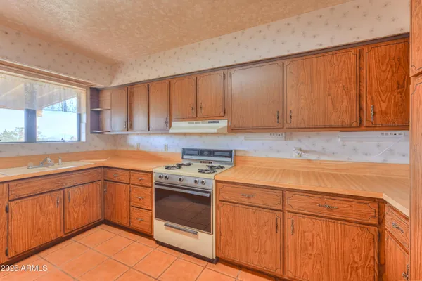 a kitchen with a sink stove and cabinets