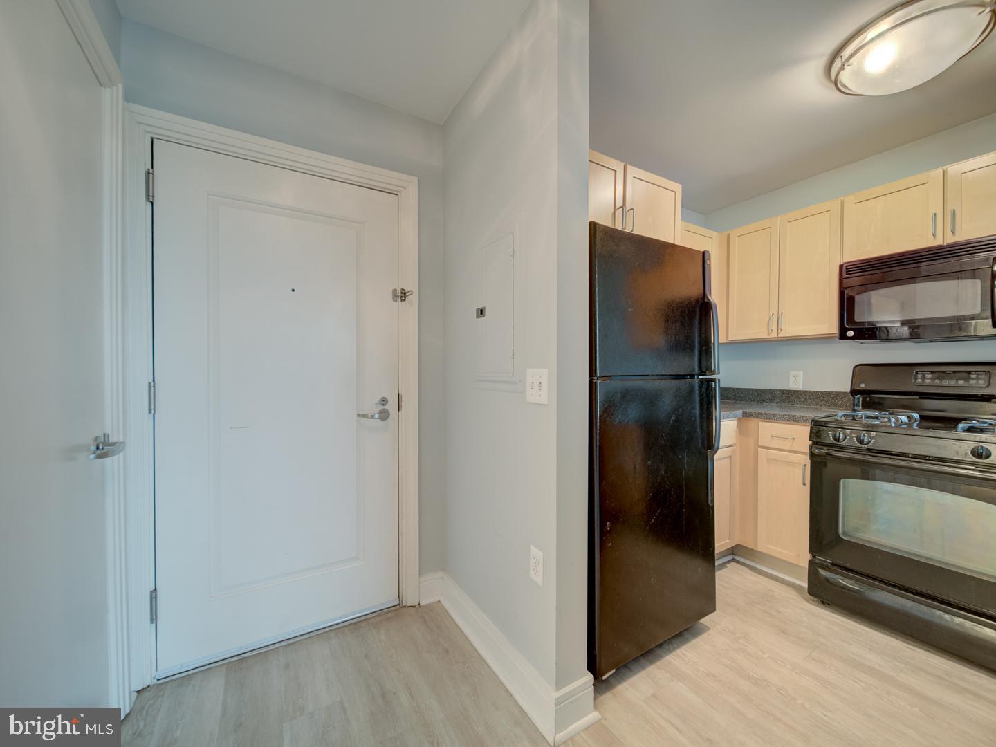 800 4th Street Southwest, Unit N703 Washington, DC 20024 - Photo 11 of 25 a kitchen with a refrigerator and a stove top oven