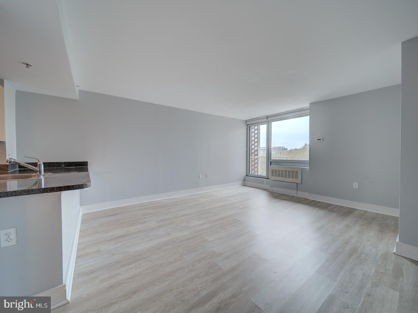 800 4th Street Southwest, Unit N703 Washington, DC 20024 - Photo 17 of 25 a view of a kitchen with wooden floor and a sink