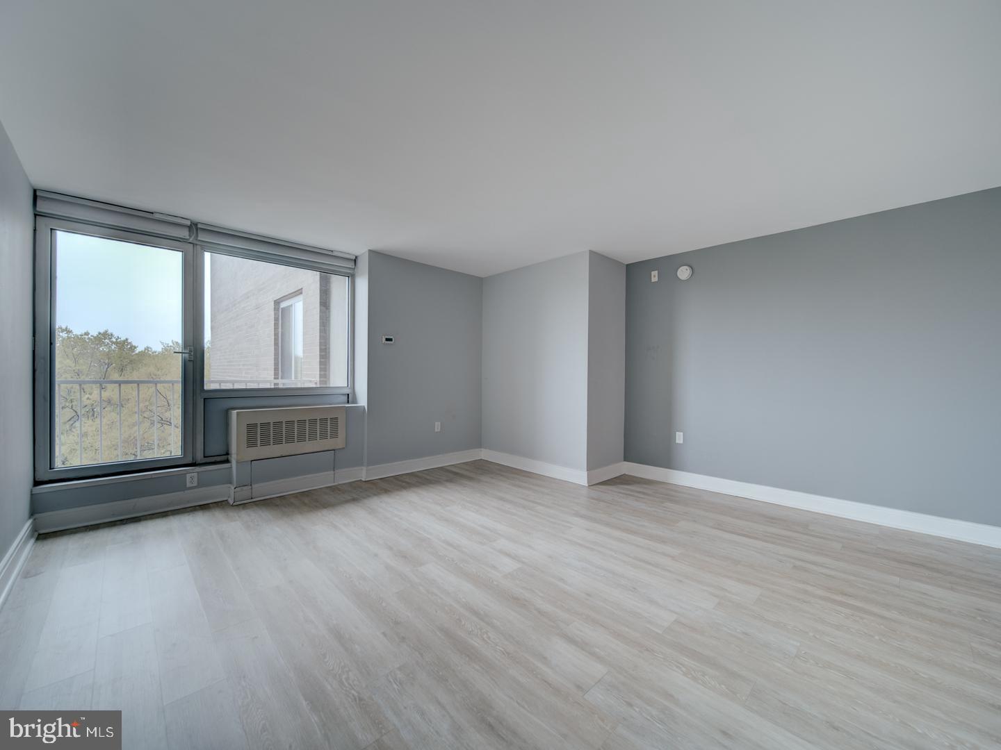 800 4th Street Southwest, Unit N703 Washington, DC 20024 - Photo 18 of 25 a view of an empty room with a window and wooden floor