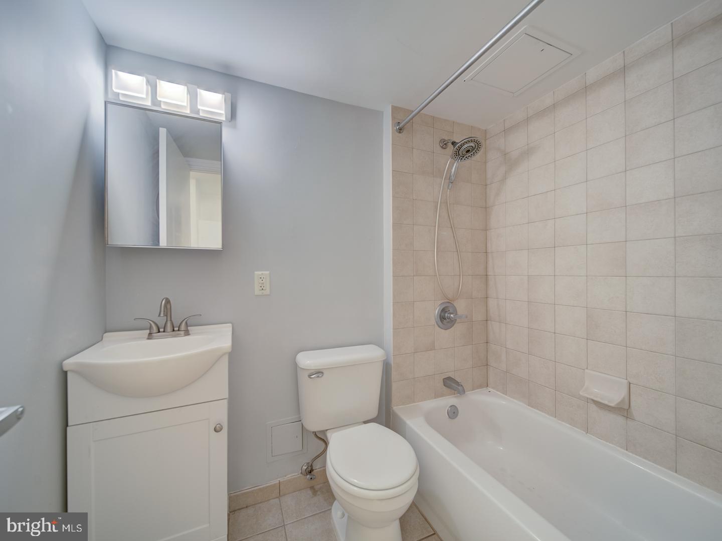 800 4th Street Southwest, Unit N703 Washington, DC 20024 - Photo 23 of 25 a bathroom with a toilet sink vanity mirror and bathtub