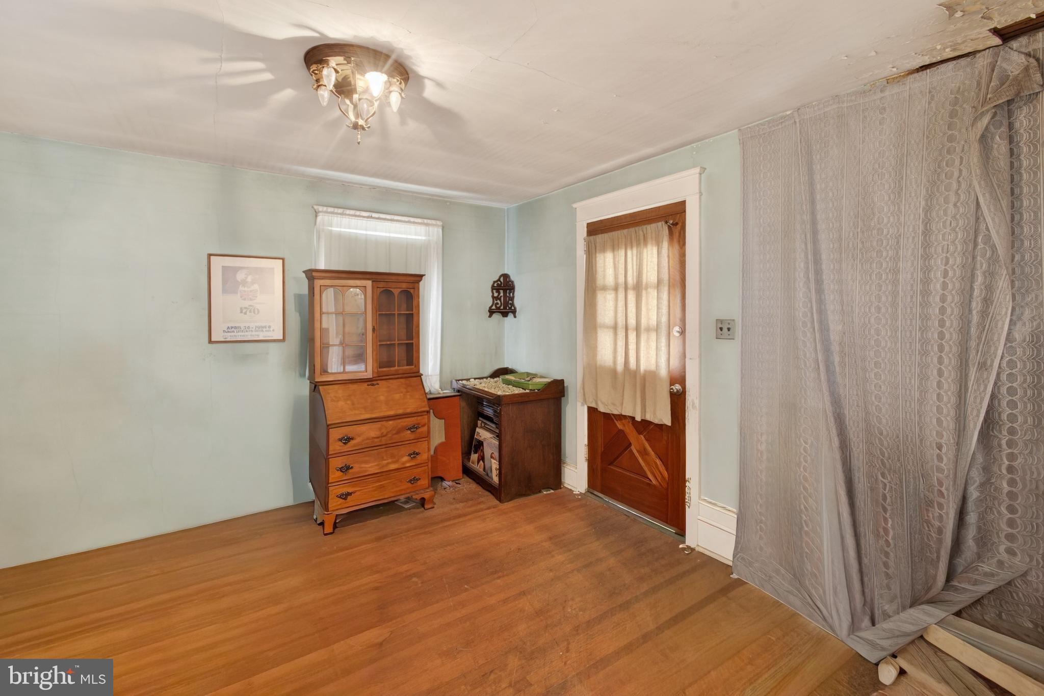 2583 Radcliffe Road Broomall, PA 19008 - Photo 2 of 12 a bedroom with a bed and a chandelier